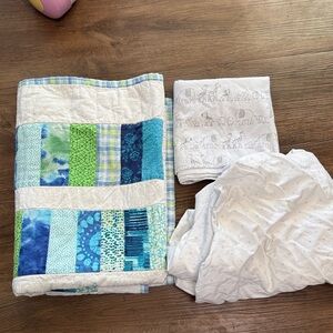 Bundle of bedding (receiving blanket, quilt and crib sheet)